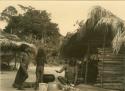 Village scene - two children, woman working