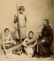 Priest or monk with three boys