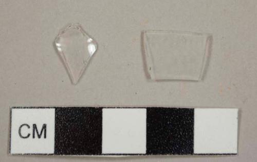 Colorless, thin curved glass fragments, possibly from lamp chimneys