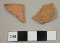 Unglazed, red earthenware fragments, including one flower pot rim fragment