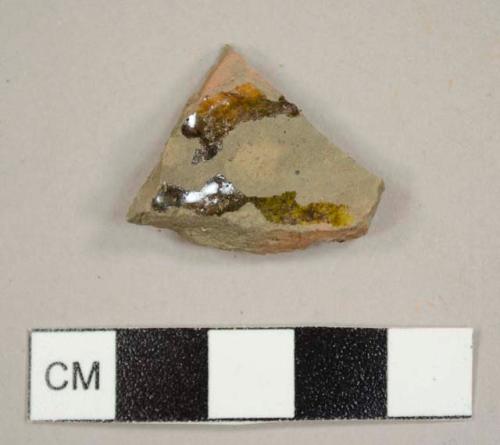 Black lead-glazed, red earthenware sherd