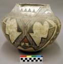 Polychrome jar. Orange and black geometric designs on white. Bands and triangles