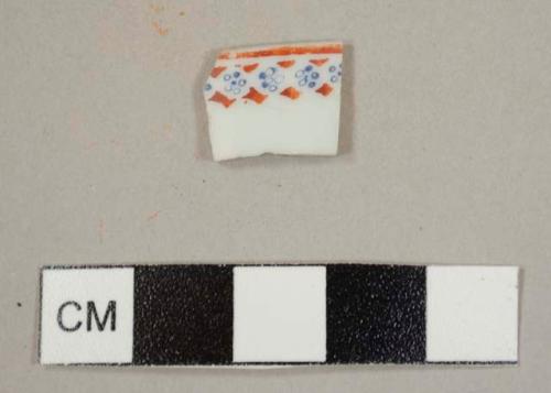 Asian porcelain cup rim sherd with red and blue overglaze