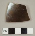Brown-glazed stoneware sherd with buff paste