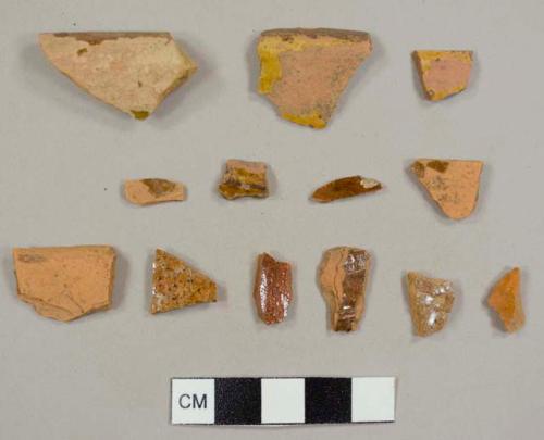 Lead-glazed red earthenware sherds, including one with slip decoration and three rim sherds from different bowls or pans