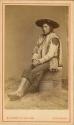 Studio staged portrait of seated man