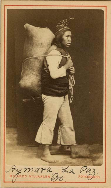 Studio portrait of man carrying large bag