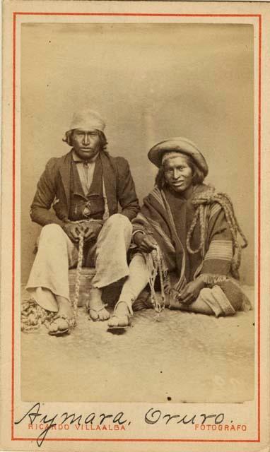 Studio portrait of two men sitting