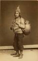 Studio portrait of man carrying large ceramic vessel