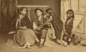 Studio portrait of four children sitting