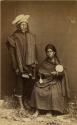 Studio portrait of man, and woman with spindle