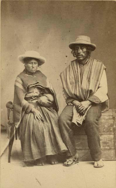 Studio portrait of man and woman sitting