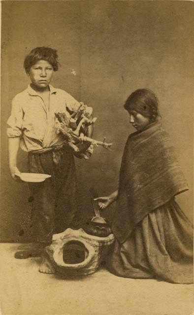 Studio portrait of boy and girl with basket