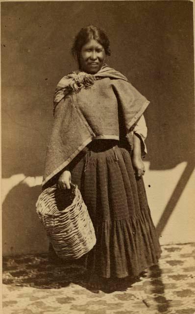 Studio portrait of woman with basket