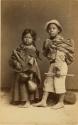 Studio portrait of two children with musical instruments