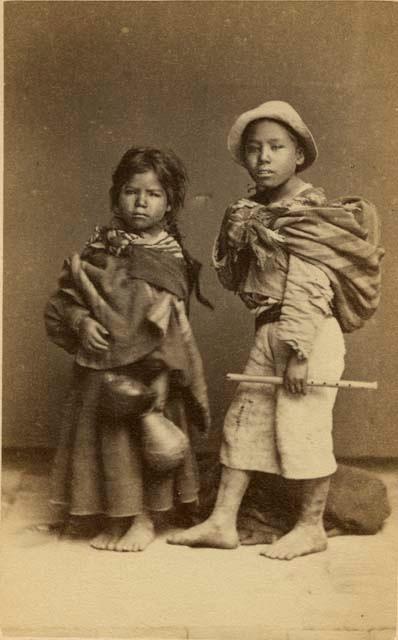 Studio portrait of two children with musical instruments