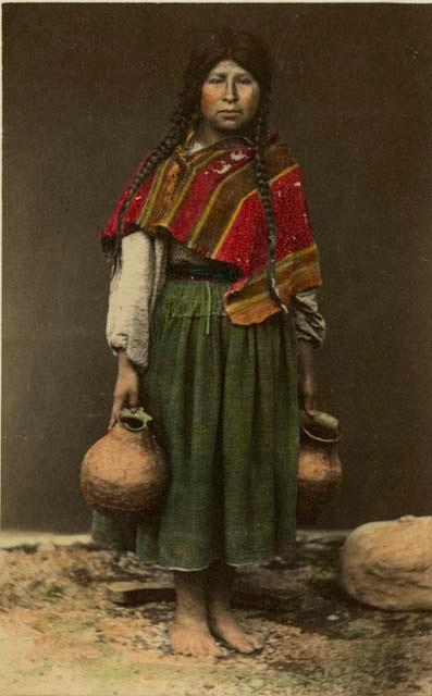 Studio portrait of woman with two ceramic vessels