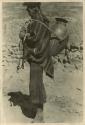 Man carrying large jar