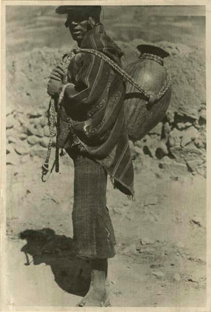 Man carrying large jar