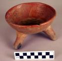 Ceramic tripod bowl, rattle legs, red on orange, incised