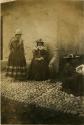 Three women next to a building