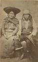 Studio portrait of woman and man sitting