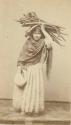 Woman carrying bundle of firewood