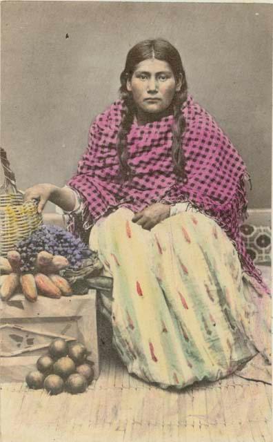 Woman sitting, with basket and fruit