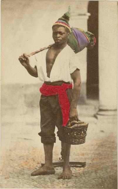 Man carrying bundle and basket