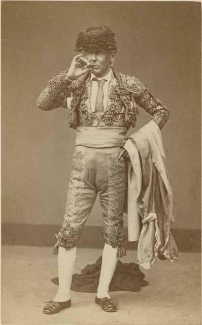 Studio portrait of man standing and smoking