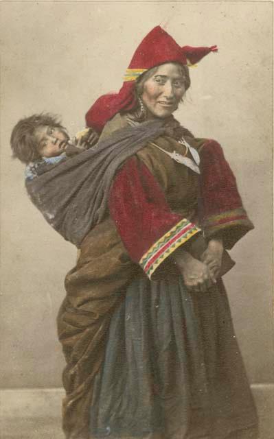 Studio portrait of woman carrying a child on her back