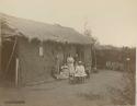 Group in front of adobe hut