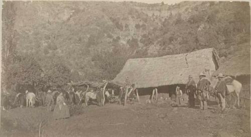 Group in front of adobe hut