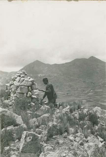 Person next to rock shrine