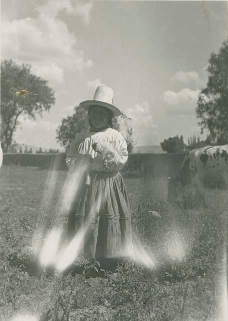 Woman standing in a field spinning