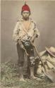 Studio portrait of boy with walking stick