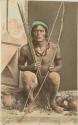 Studio portrait of man with bow and arrows