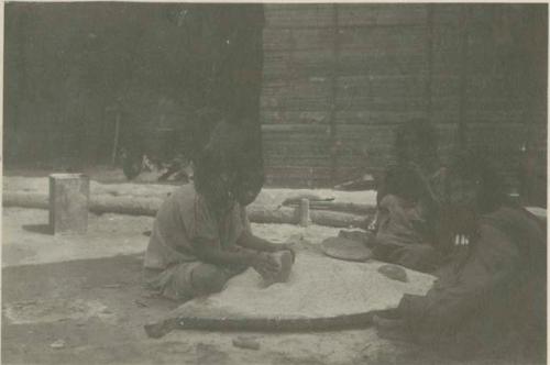 Women grinding corn