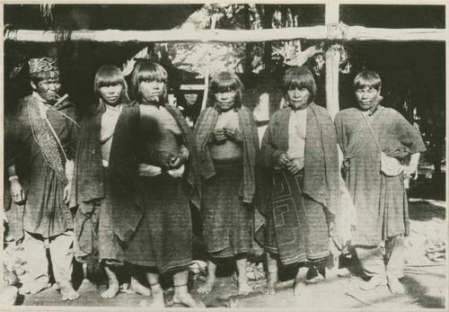 Two men and four women standing in front of a structure