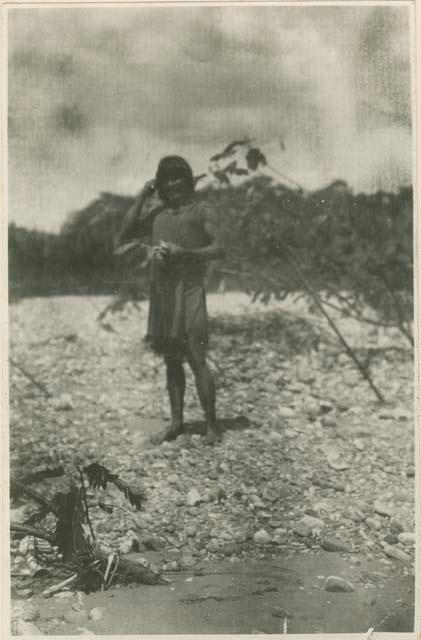 Man standing on rocky shore line