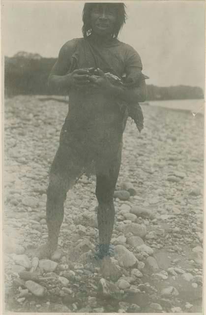 Man standing on rocky shore line