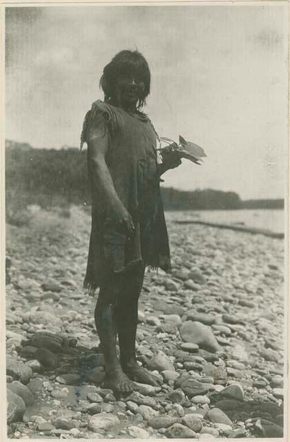 Man standing on rocky shore line