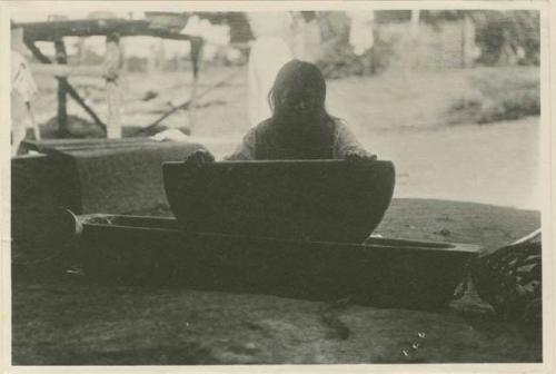 Woman grinding corn