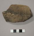 Ceramic rim sherd, dentates along rim, impressed design on body