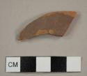 Red earthenware sherd with brown slip glaze on interior and exterior