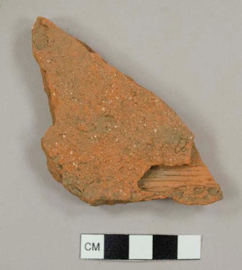 Handmade brick roof tile fragment with grove near one edge, possibly the result of spalling