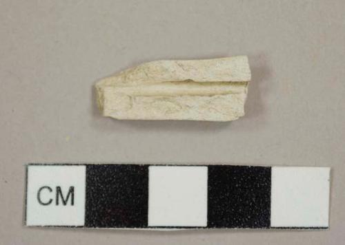 Kaolin/White ball clay pipe stem fragment, split lengthwise, with a 5/64 in bore diameter