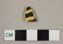 Staffordshire-type slipware sherd with black and yellow lined slip