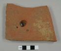 Ceramic roof tile with nail hole near center 1.6 cm diameter outside and 0.7 cm inside