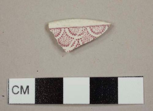 Red-purple transfer-printed whiteware rim sherd to a saucer or shallow bowl